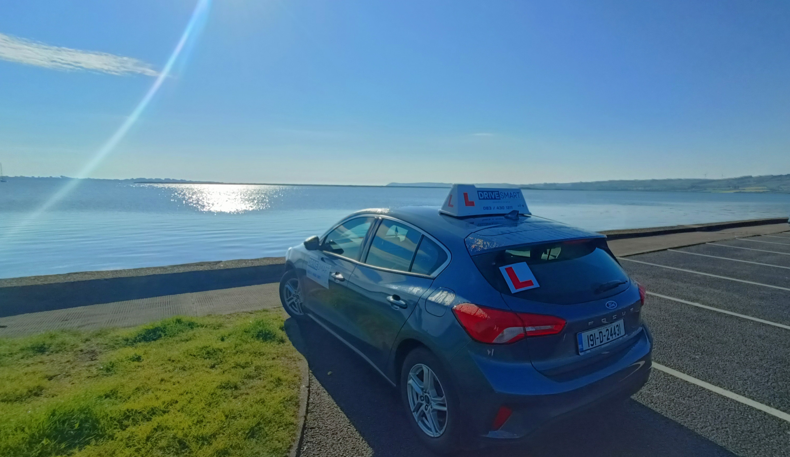 Blue Drive Smart learner car parked beside the coast