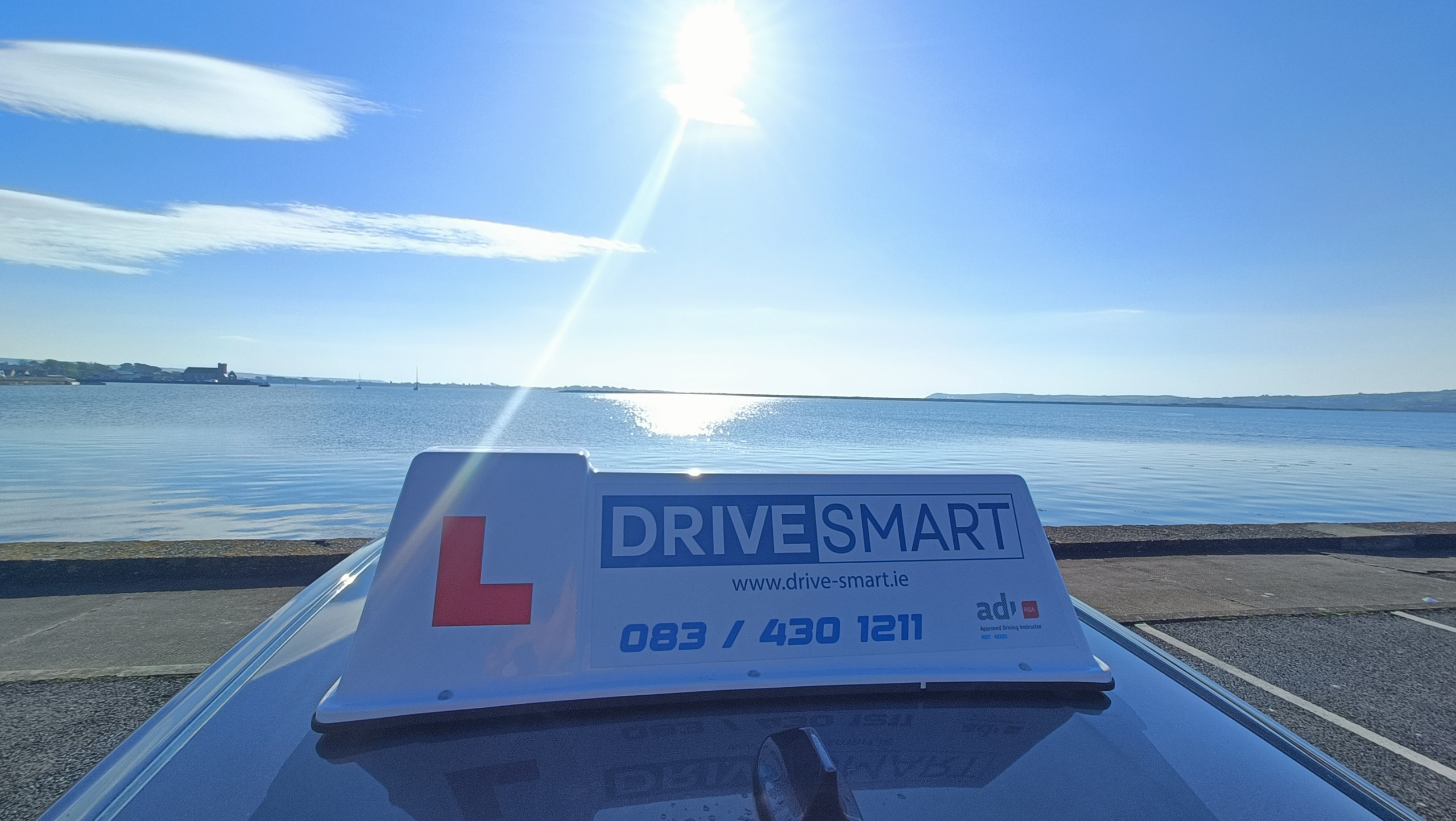 Drive Smart roof sign beside the coast